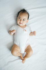 Asian baby lying on bed with soft blanket indoors cute little asian newborn baby