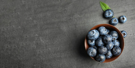 Tasty fresh blueberries on grey background, top view with space for text. Banner design