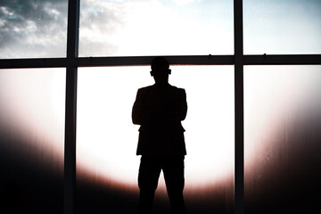 background image. businessman standing near the window