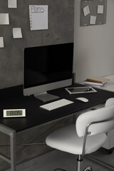 Stylish room interior with comfortable workplace near grey wall