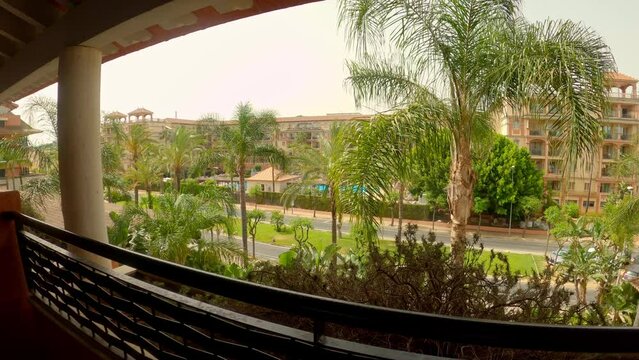 Slow motion shot View from balcony of Luxury resort, Tropical Trees, Spain. Islantilla