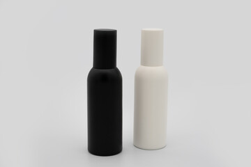 black and white spray bottle with a cap for containing alcohol