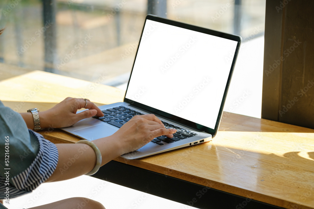 Poster a woman using a computer laptop with a blank white screen. the blank space on the white screen can b