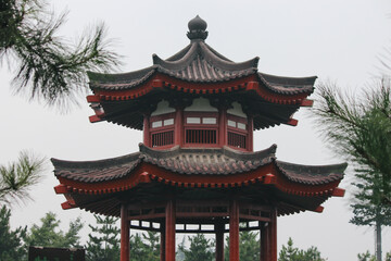 photograph of a Chinese garden with a red pavilion with Chinese architecture