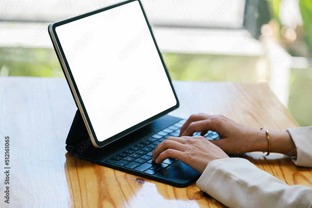 Poster a woman using a tablet with a blank white screen. the blank space on the white screen can be used to