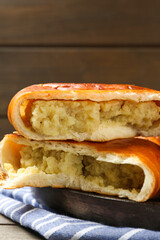 Delicious baked patties with potato on wooden table, closeup