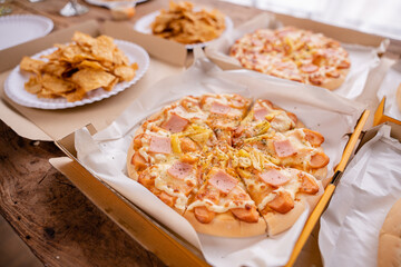 Freshly baked pizza just out of the oven on a wooden board.