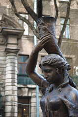 sculpture by the tree against the backdrop of the house