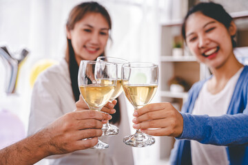 Bravo! group of young people clinking glasses Cheerful enjoying food and drink while together in the office. Focus on the glass.