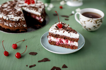 Cherry cake and chocolate on the background with flowers