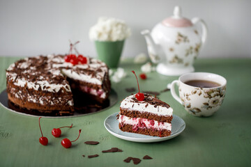 Cherry cake and chocolate on the background with flowers