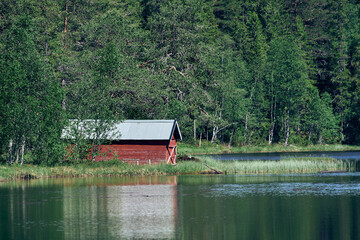 red wooden boat house on the lake