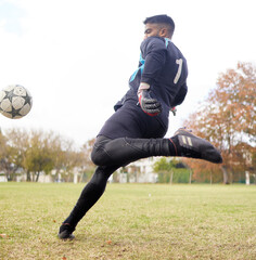 Exercise not only changes your body, it changes your mind. Shot of a young man playing soccer on a...