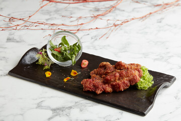 Crispy-fried Fragrant Iberico Pork served in a dish isolated on grey background