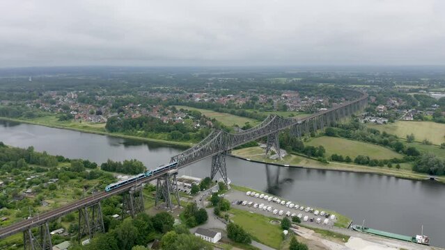 Train moving on the railway (Neum&uuml;nster&ndash;Flensburg line) at Rendsburg High Bridge (Rendsburger Hochbr&uuml;cke)