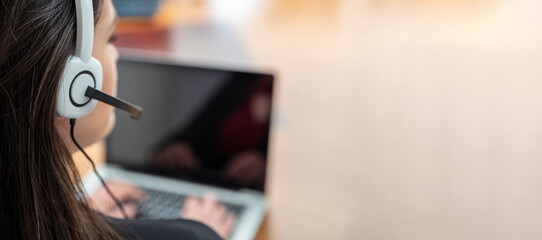 Customer support, call center, help desk concept. Woman with headset work on a laptop