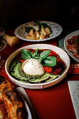 Burrata Italian fresh cheese made from cream and buffalo or cow milk; belongs to the mozzarella cheese family