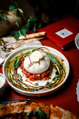 Burrata is an Italian fresh cheese made from cream and buffalo or cow milk; belongs to the mozzarella cheese family.