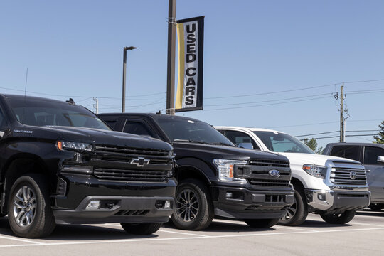 Used pickup trucks at a dealership. With supply issues, used and preowned cars are in high demand.