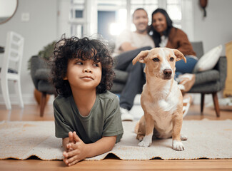 Chilling with my favourite companion. Shot of a little boy bonding with his dog while his parents sit in the background.