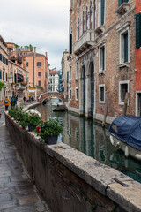 Narrow canal in the city of Venice on a summer day
