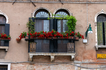 Fototapeta na wymiar Old balcony in Venice on a summer day