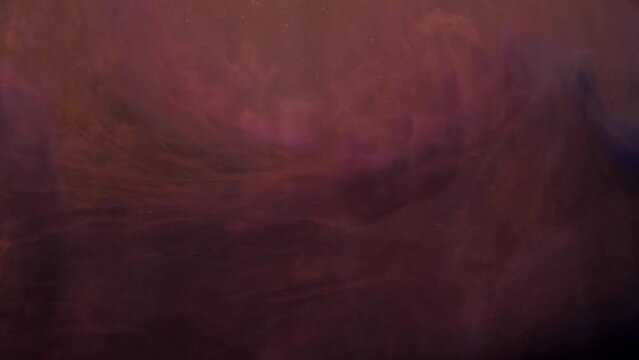 Slow motion orange and pink ink acrylic paint mixing in water, swirling softly underwater. Acrylic cloud paint in aquarium. Slowmotion abstract smoke explosion animation. Beautiful art background