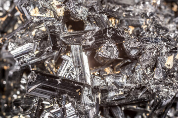 Tourmaline black crystals. Gems. Mineral crystals in the natural environment. Texture of precious and semiprecious stones. Seamless background with copy space colored shiny surface of precious stones.