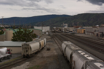 Railroad yard in rural town with train cars