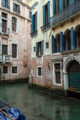 Fototapeta na wymiar Narrow canal in the city of Venice on a summer day