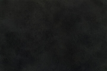 Dark background of decorative plaster with abstract spots. Unusual black or gray wall texture with beautiful patterns, creative surface background. Finishing coating for building cladding.