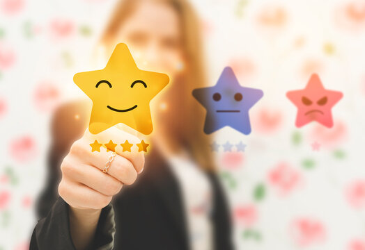 Woman choosing happy smile face on five star excellent rating virtual touch screen, good feedback rating and positive customer review,experience, satisfaction survey,mental health assessment