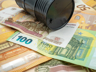 euro banknotes and russian ruble and oil barrel concept photo
