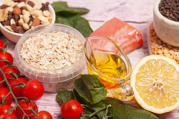 Balanced diet food background. Organic food for healthy nutrition, vegetables,hercules,olive oil,fish,herbs,nuts,dried fruits, seeds and greens