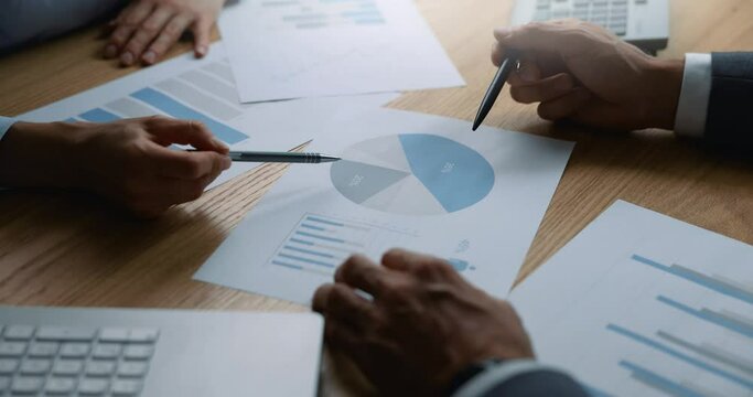 business people discussing business marketing strategy and analyzing report charts at office desk