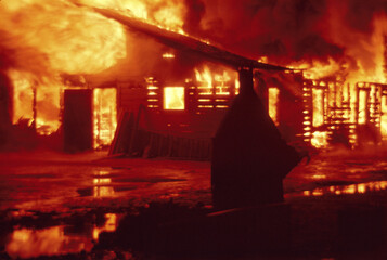 Abandoned house fully engulfed in flames