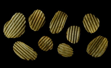 Set potato chips, crisps isolated on black, top view