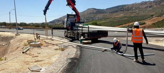 assembly and installation of electric poles 15 meters high, lighting of long-distance roads,...