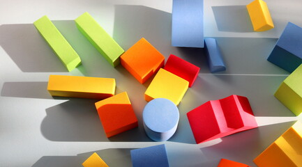 Geometric multicolored baby shapes close-up on a blue background selective focus