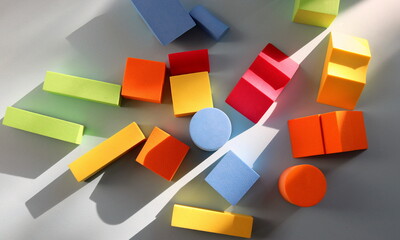 Geometric multicolored baby shapes close-up on a blue background selective focus