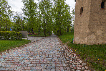 Fototapeta premium Beautiful view of pavement in park lined with old cobblestones in historic center. Sweden.