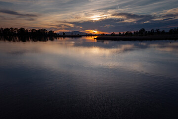 Colorful Sunset With Cloudy Sky Over a Reflecting Pond