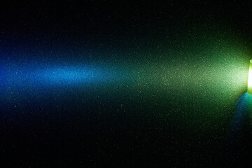 Yellow and blue transient bright gradient beam of light on black background