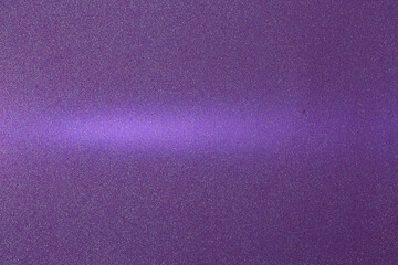On a purple background in fine grain, a lilac ray of light