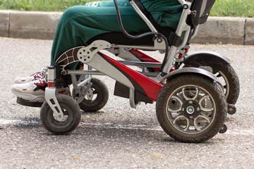 Fototapeta na wymiar Wheelchair and cropped man in it in park