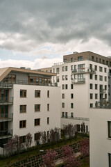 Fototapeta na wymiar Modern low-rise apartment building. Condominium with white facades and windows