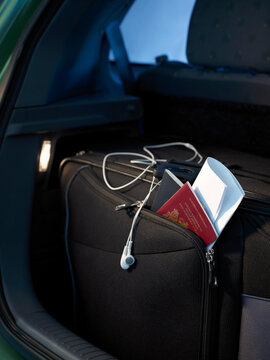Travel documents and passport and travel bag in back of car