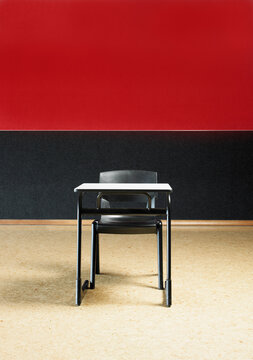 Lone desk and chair in empty room