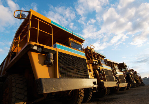 Row of large dumptrucks parked in quarry