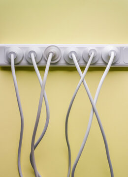multiple plugs pulgged into panel of multiple sockets